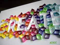 the word creation is made out of colored paper