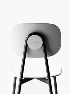 two white chairs sitting next to each other