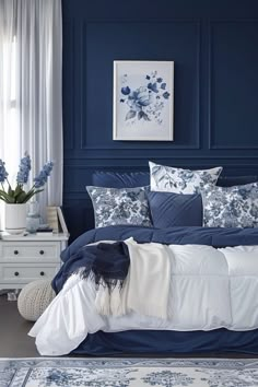 a bedroom with blue walls and white bedding in the center, along with an area rug on the floor