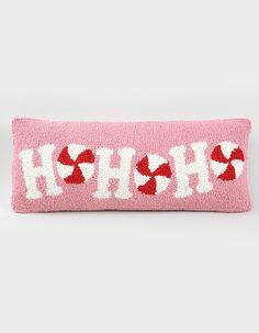 a pink pillow with red and white hearts on it