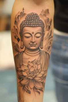 a person with a tattoo on their leg and a buddha statue in the middle of it