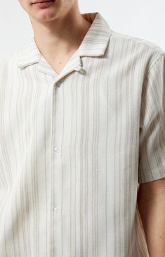 Step into summer with polished style in the Weave Stripe Woven Camp Shirt from PacSun. Featuring a collared neckline, short sleeves, and a regular fit, this shirt offers timeless sophistication. Complete with button closures and a woven striped pattern, it's the perfect choice for elevating your warm-weather wardrobe with ease.


	Collared neckline
	Short sleeves
	Button closures
	Regular fit
	Woven striped pattern
	76% Cotton, 15% acrylic, 8% polyester, 1% fibers
	Machine washable
	Model is wearing size medium
	Model Measurements: 6'1.5” Height, 28” Waist, 32” Inseam Collared Beach Shirt With Placket, Beige Collared Shirt For Summer, Beige Collared Summer Shirt, Summer Short Sleeve Camp Shirt With Placket, Classic Johnny Collar Camp Shirt For Summer, Beige Summer Shirt With Button Closure, Beige Button Closure Shirt For Summer, Classic Summer Camp Shirt With Spread Collar, Collared Shirt With Button Closure For Summer