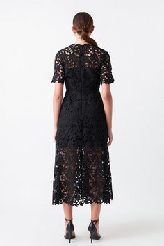 All over lace body midi dress, featuring see through short sleeves, attached lining, tuck details at skirt, and center back invisible zipper closure. Available in black. Shell: 100% Polyester Lining: 80% Polyester, 20% Cotton