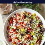 a white bowl filled with lots of food on top of a table