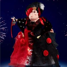 an animated character dressed in red and black with fireworks behind her on a blue background