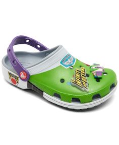 a child's green and purple clogs with cartoon characters on the bottom