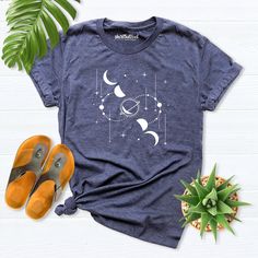 Moon shirt, Moon Phases shirt, Space moon shirt, Astrology Shirt, Astronomy shirt women, Moon Stars Shirt, Space Lover Gift, Celestial Shirt Hello! Thank you for supporting small businesses. My main priority here is the satisfaction of my customers.   If you want to see this design on the SWEATSHIRT you can buy it from the link below.https://etsy.me/3LS0Viz T-shirts are comfortable cut. I recommend checking the size and color charts before placing your order. If you want a text on the back of yo Astronomy Shirt Design, Relaxed Fit Graphic Tee With Moon Print, Relaxed Fit Moon Print Graphic Tee, Celestial Short Sleeve Tops With Moon Print, Picture Cube, Space Lovers Gifts, Moon Phases Shirt, Celestial Shirt, Stars Shirt