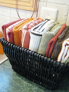 a wicker basket filled with towels on top of a counter