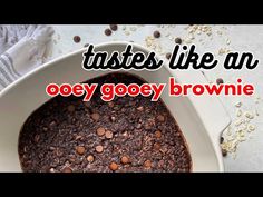 there is a brownie in a white bowl with chocolate chips on the side and text that reads tastes like an ooey gooey gooey brownie