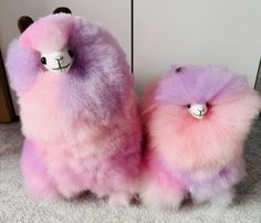 two stuffed llamas sitting next to each other