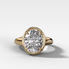 a gold ring with a white diamond in the center