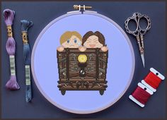 cross - stitch kit with scissors, thread and sewing supplies including needle and button holder