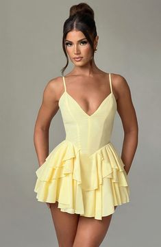 Wear this pretty playsuit on repeat. cut from our premium chiffon which is super floaty and lightweight. Featuring a layered ruffle skirt with built in shorts. this plunge neck design is backless with adjustable straps for your perfect fit. Partner with barely there heeled sandals and a bright bag.   Colour: Lemon. Premium non-stretch chiffon. Fully lined. Layered ruffle skirt with built in shorts. Plunge neckline. Adjustable straps. Internal tie at waist. Backless design. Invisible zipper to reverse. Mini length. Model is an XS and is wearing an XS. Gaun Koktail, Club Party Dresses, Maxi Dress Sale, Sparkle Dress, Backless Mini Dress, Mini Dresses For Women, Ruffle Mini Dress, Dresses By Length, Look At You