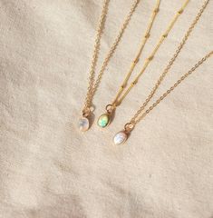 Our Dainty gemstone necklace features a tiny little stone, choose between opal, moonstone and turquoise. DETAILSGOLD VERSION:•PENDANT is Genuine Turquoise, Genuine Moonstone, or Synthetic Opal, measuring 5 x 7mm•CHAIN is 14k Gold Filled•CLASP is 14k Gold Filled Matching ………………………………….PERSONALIZE IT! ADD A STAR INITIAL CHARM:https://www.etsy.com/ca/listing/627638174/add-a-star-initial-charmADD A STAMPED INITIAL:https://www.etsy.com/ca/listing/561708083/add-an-initialADD A BIRTHSTONE:https://www.e Dainty Adjustable Moonstone Necklace, Dainty Adjustable Opal Necklace, Dainty Opal Adjustable Necklace, Dainty Everyday Necklaces With Natural Stones, Everyday Opal Jewelry With Gemstones, Everyday Opal Gemstone Jewelry, Dainty Oval Adjustable Necklace, Adjustable Dainty Oval Necklace, Delicate Opal Gemstone Jewelry