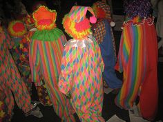 several clowns in colorful costumes are standing together