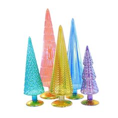 colorful glass christmas trees are lined up against a white background