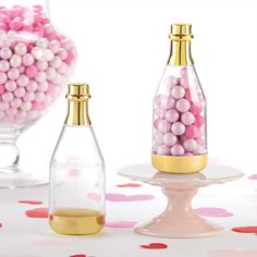 pink and white candies in glass bottles on a table