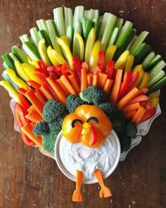 a turkey shaped vegetable platter with carrots, broccoli and celery