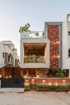 an apartment building with plants growing on the balconies