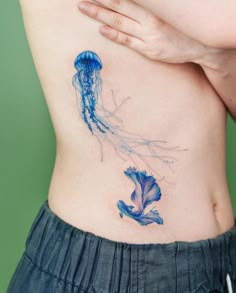 a woman with a jellyfish tattoo on her stomach