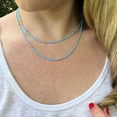 Dainty Layered Beaded Necklace with Blue and Beige/White Czech Glass Beads. Super Lightweight! Beads: * Blue Czech Glass - 1mm * Beige Seed Beads - 2mm * 10K Gold Spacer Beads - 2mm Clasp: *10K Gold Plated Lobster Claw Clasp  * The model in the pictures is wearing 16 & 18 inches.  Choose your Lengths at Checkout! If you don't see a certain length in the drop down menu, please message me with the lengths you would like :)  To view more of my original jewelry designs, visit: https://www.etsy.com/s Colorful Beads Turquoise Necklace For Beach, Blue Round Beads Necklaces For Summer, Bohemian Blue Strand Jewelry, Blue Bohemian Strand Jewelry, Blue Spacer Beads Jewelry For The Beach, Beach Turquoise Necklace With Round Beads, Handmade Blue Turquoise Necklace For Summer, Light Blue Round Beads Necklace For The Beach, Summer Blue Necklaces With Spacer Beads