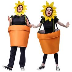 two women dressed in sunflower costumes, one holding an orange bucket and the other wearing black