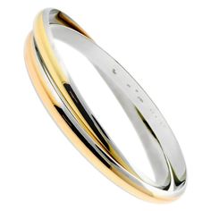 An iconic Cartier bangle crafted in 18k yellow and rose gold and stainless steel. The design is bold and modern, and at the same time soft and mellow. One cannot help admire the form of this breathtaking Cartier yellow and rose gold and stainless steel bangle bracelet for its simplicity as well as its depth. Size: Medium Modern Cartier Bangle Bracelets, Modern Cartier Bangle Bracelet, Modern Cartier Gold Bracelet, Modern Cartier Bangle With Polished Finish, Cartier Modern Yellow Gold Bangle, Modern Cartier Yellow Gold Bangle, Modern Cartier Bangle For Formal Occasions, Modern Cartier Gold Bangle Bracelet, Modern Cartier Round Bangle