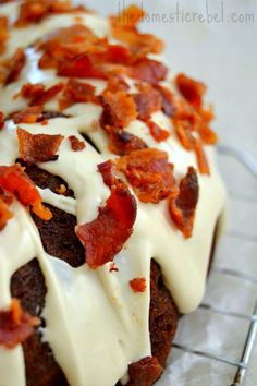 bacon and white frosting on top of a bundt cake