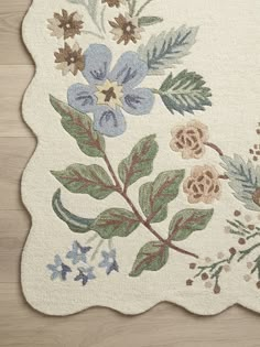 a rug with flowers and leaves on it