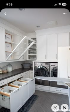 an appliance in a kitchen with white cabinets and drawers