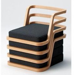 a stack of four wooden chairs sitting next to each other on top of a white floor