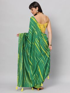 This light weight Green Tie dye saree is a versatile saree that is a must have in your wardrobe. This saree is extremely light weight will give you great pitures and can be worn for different ocassions. Team this saree up with Yellow raw silk blouse & statement earrings. Suitable for Poojas, Day function, brunhes, Wedding & haldi functions. Product Features: Saree Color: Green & yellow Blouse Color: Yellow Saree Fabric: Georgette silk Blouse Fabric: Raw Silk Saree Work: Tie Dye Print Wash Care: Green Semi-stitched Saree Traditional Wear, Semi-stitched Green Blouse Piece For Diwali, Green Art Silk Blouse Piece For Diwali, Green Semi-stitched Tussar Silk Traditional Wear, Green Tussar Silk Traditional Wear For Navratri, Designer Green Saree For Eid, Green Designer Wear Saree For Eid, Traditional Green Handloom Choli, Diwali Green Art Silk Blouse Piece