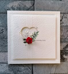 a white card with a red rose on it