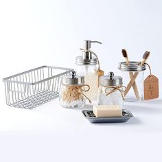 bathroom accessories including soap and toothbrushes are arranged on a white surface with a metal basket