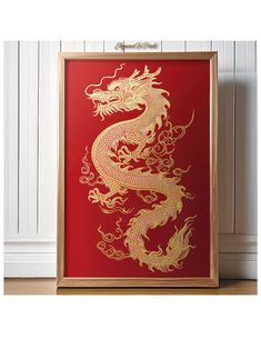 a red and gold framed art print with a golden dragon on it's side