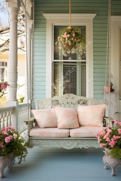 a porch swing with pink flowers on it