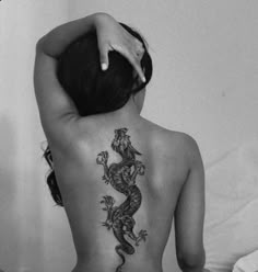 a woman with a tattoo on her back