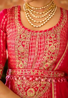 Step into refined elegance with the scarlet red maroon hand-embroidered pleated silk brocade kurta and lehenga set. The pleated brocade kurta is adorned with intricate hand embroidery, perfectly complemented by a flowing multi-panel brocade lehenga. An embroidered belt adds structure, while the matching dupatta completes this ensemble, making it a stunning choice for any grand occasion. Red Dola Silk Kurta For Navratri, Navratri Red Dola Silk Kurta, Red Anarkali Sharara For Reception, Festive Anarkali Kurta For Reception, Red Lehenga With Dori Work, Elegant Red Anarkali Set With Cutdana, Red Dola Silk Anarkali Set For Diwali, Red Chinon Straight Kurta Traditional Wear, Red Straight Kurta In Chinon