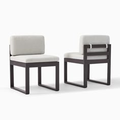 two chairs sitting next to each other in front of a white background with no one on it