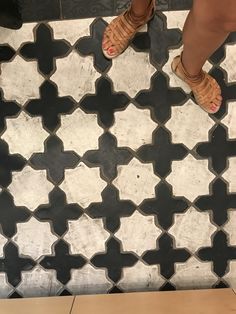 a person standing on top of a tiled floor