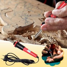 a person is working on some wood with a soldering tool and other things in the background