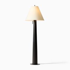 a lamp that is sitting on top of a table next to a white wall and floor