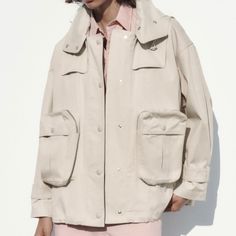 Brand New Cream Cargo Jacket/Coat/Trench Oversized With Large Pockets And Zippers. Hooded. Everyday Hooded Utility Jacket With Pockets, Oversized Khaki Parka For Streetwear, Spring Streetwear Outerwear With Patch Pockets, Urban Oversized Khaki Windbreaker, Casual Oversized Outerwear With Multiple Pockets, Oversized Spring Shacket For Streetwear, Spring Collared Shacket With Multiple Pockets, Oversized Utility Windbreaker, Hooded Utility Jacket With Patch Pockets For Work