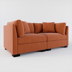 an orange couch with several pillows on the arm and back cushions, sitting in front of a white wall