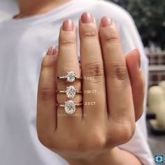 a woman's hand with three different rings on it and the size of her ring