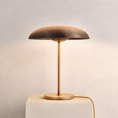 a table lamp sitting on top of a white block