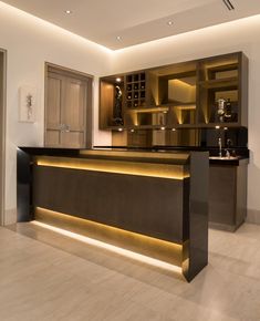 a modern kitchen with an illuminated bar and cabinets in the back ground, along with marble flooring