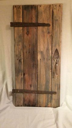 a piece of wood that is made to look like a door with an iron handle