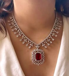 Add a touch of glamour and sophistication with this high quality red ruby pendant necklace set in beautiful zirconia stones. The stones in this set bling and look close to the real thing. This set is sure to make heads turn!  It features an adjustable necklace and a pair of earrings. It can be paired perfectly with both ethnic and western outfits.  Gorgeous fine quality Emerald CZ lab diamonds studded pendant set  in White gold plating and matching Earrings  *Comes with Statement matching earrin Luxury Rose Cut Diamond Jewelry Sets For Wedding, Luxury Oxidized Jewelry For Engagement, Luxury Traditional Necklace For Marriage, Luxury Traditional Necklaces For Marriage, Luxury Fusion Style Ruby Necklace, Luxury Multi-stone Necklace For Wedding, Luxury Engagement Necklaces For Valentine's Day, Luxury Bollywood American Diamond Danglers, Luxury Ruby Temple Necklace For Festive Occasions