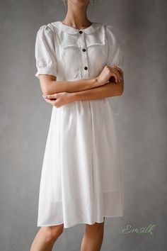 "This design linen dress is perfect for summer and fall! 100 % designed and handmade by Emsilk. I am pleased to offer your garments made to measure at no extra cost. * Detail: - Collared neckline - Coconut buttons on the front - Small gathered decoration on the front - Fit and flare bottom - Fully lined - Invisible zipper on the back - Below the knee length - High quality linen, washed linen, soft linen - The model is 5'6\" tall and wearing size S. * Care: - Dry clean or machine washed with cold Short Sleeve Fitted Linen Dress For Day Out, Puff Sleeve Vintage Dress For Summer, White Puff Sleeve Vintage Dress For Summer, Linen Puff Sleeve Dresses For Day Out, Chic Short Sleeve Linen Dress With Buttons, Linen Puff Sleeve Dress For Daywear, Knee-length Puff Sleeve Summer Dress, Elegant Vintage Short Sleeve Summer Dress, Summer Vintage Midi Dress For Daywear